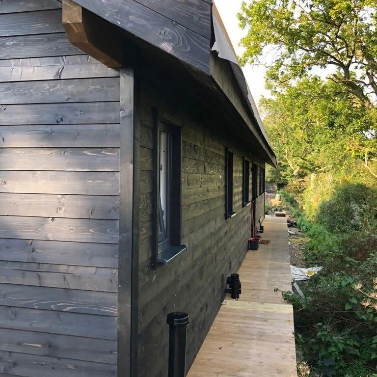 Dark treated horizontal timber cladding detail