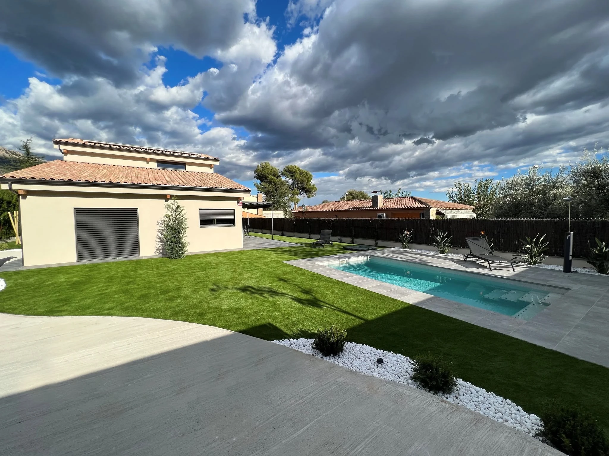 Poolside exterior view of the Barcelona timber residence