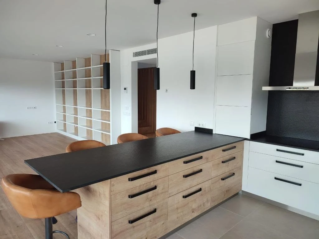 Open-plan kitchen and living area inside the Barcelona timber residence