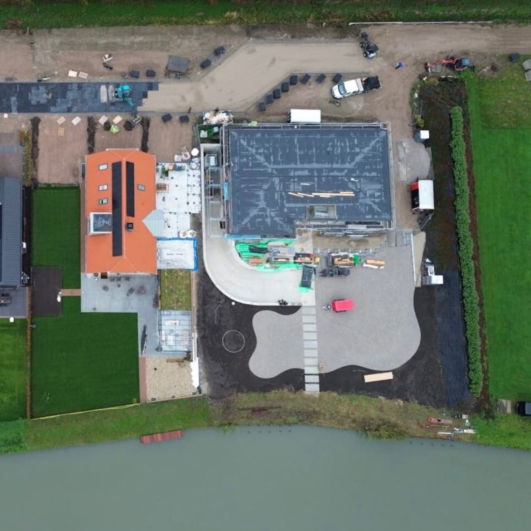 Top-down aerial view of the De Lier residence beside the water