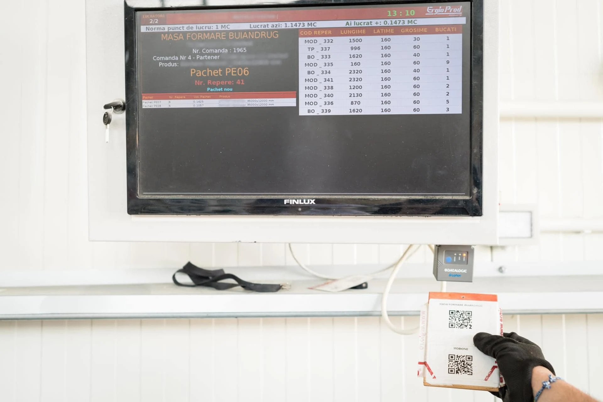 Digital production control screen and QR-coded production documentation inside the ERGIO factory