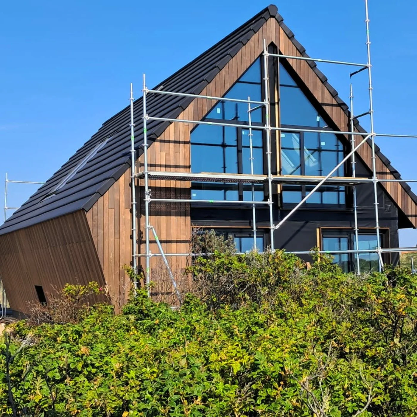 Dutch timber and steel hybrid residence with coordinated glazed gable