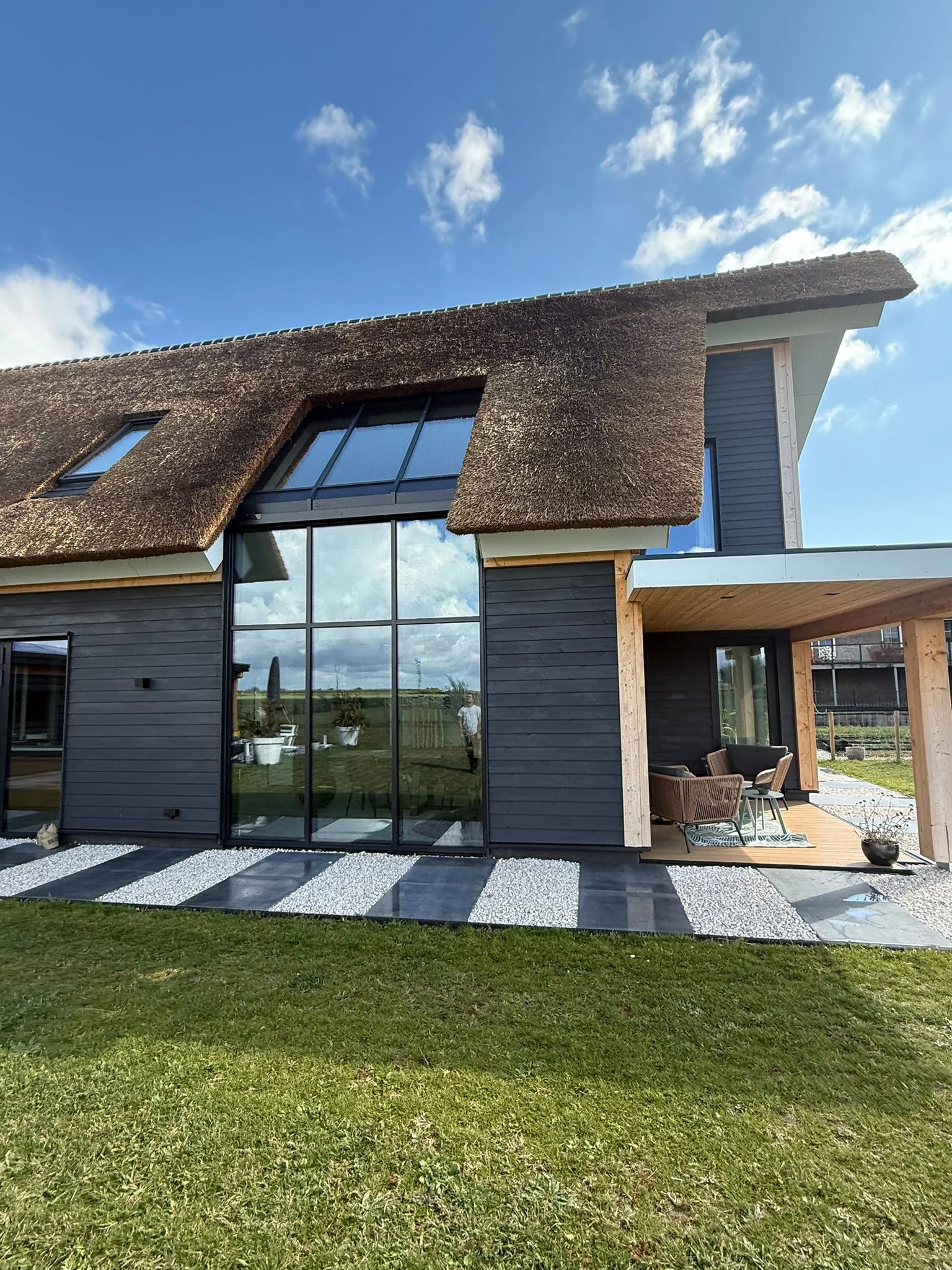 Ed timber residence main approach façade with thatched roof