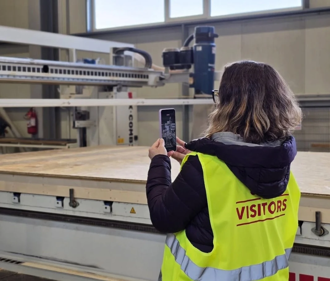 Visitante observando la línea MobiOne de producción automatizada de paneles Timber Frame