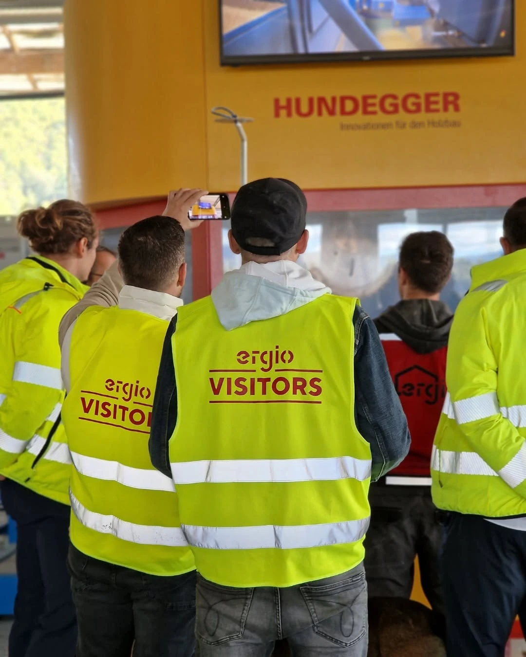 Visitors observing timber production in the ERGIO factory