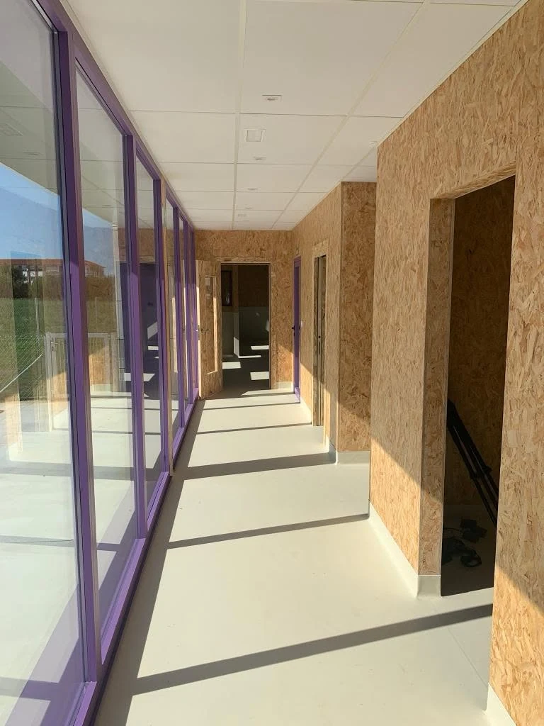 Sunlit internal corridor with OSB walls