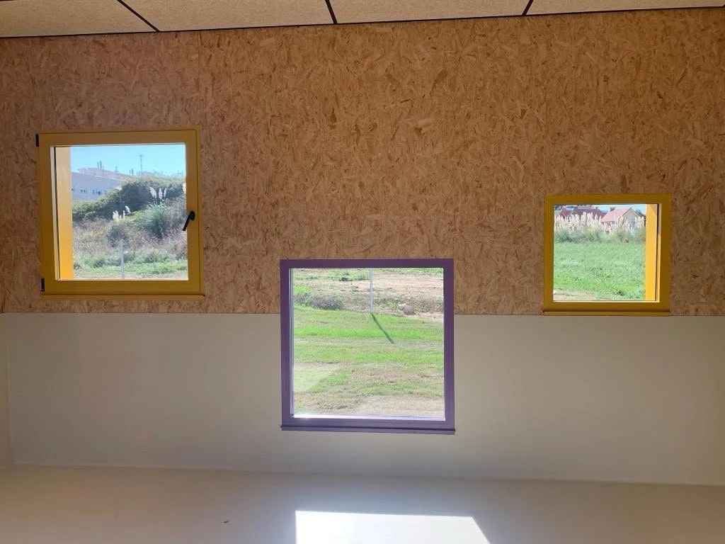 Child-height coloured windows inside the kindergarten