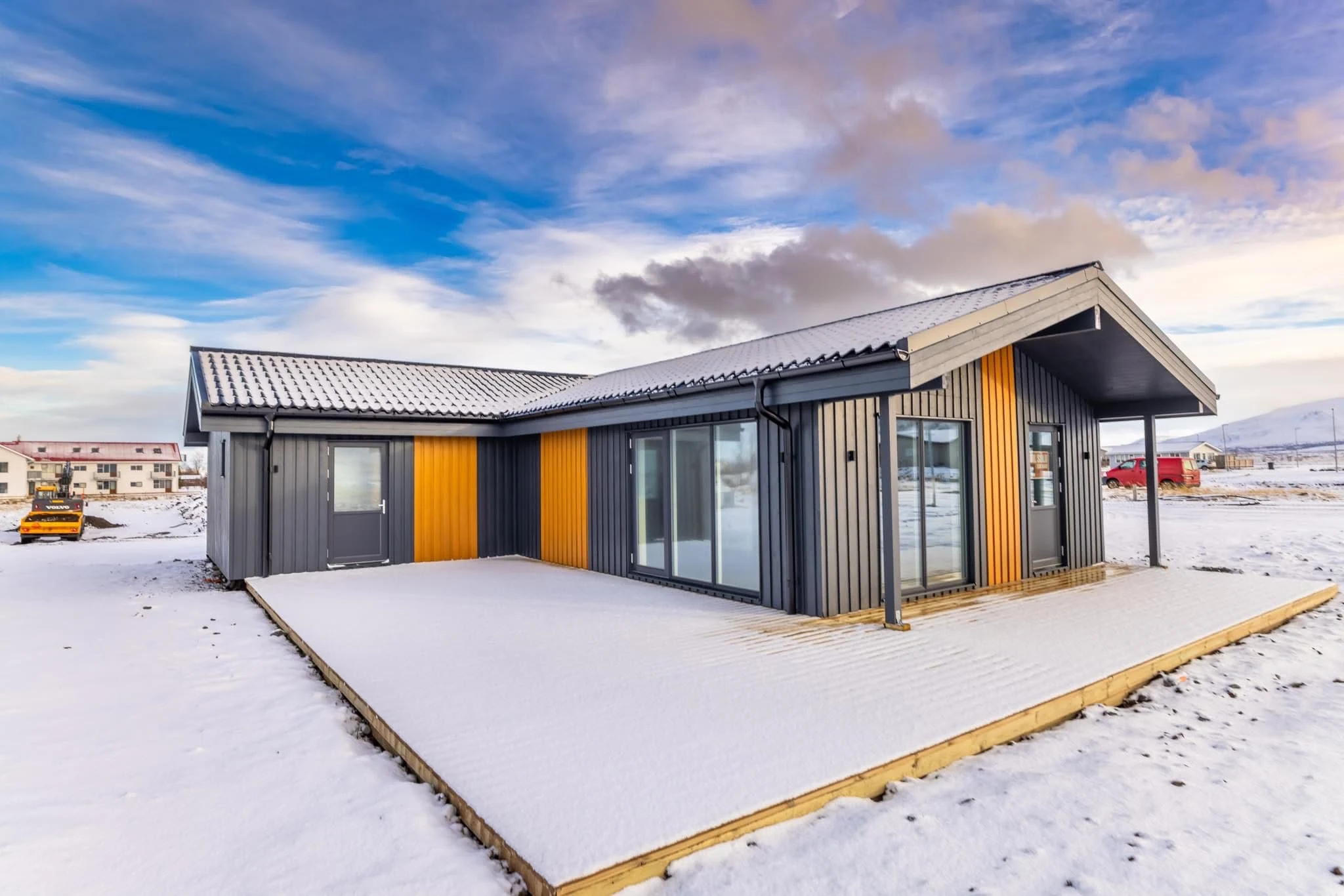 Completed timber-frame house in Iceland with snow-covered roof