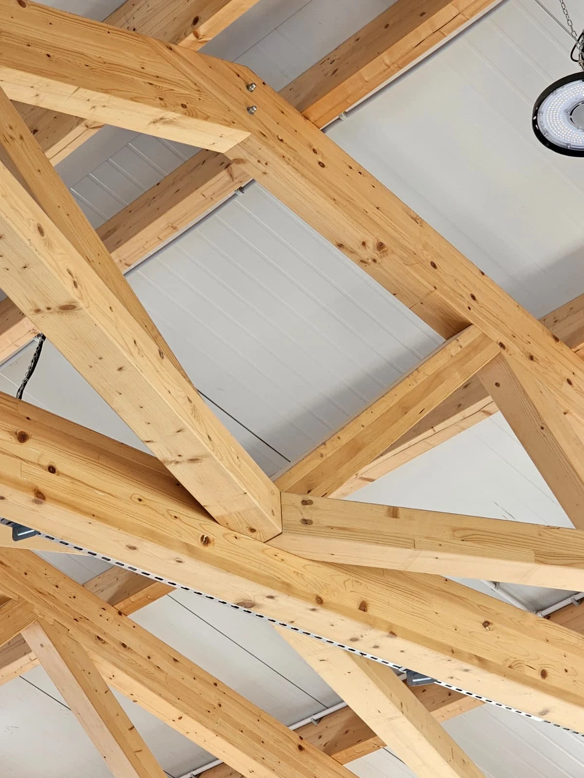 Large timber beam intersection within an industrial roof structure
