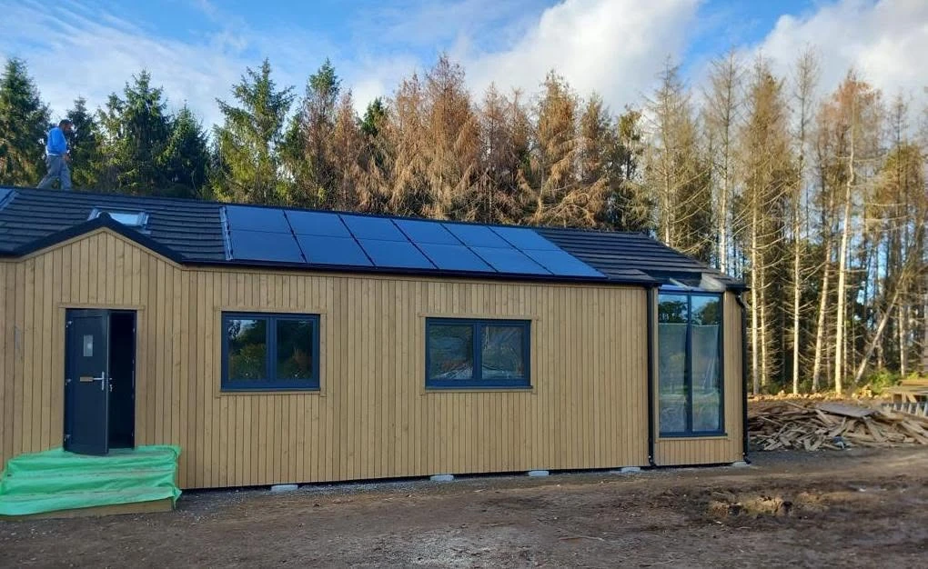 Wide view of the Megane Fletcher mobile residence with roof-mounted photovoltaic panels