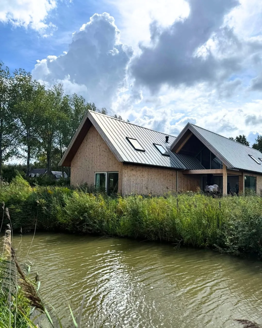 Post and Beam residence beside a landscaped waterway in the Netherlands