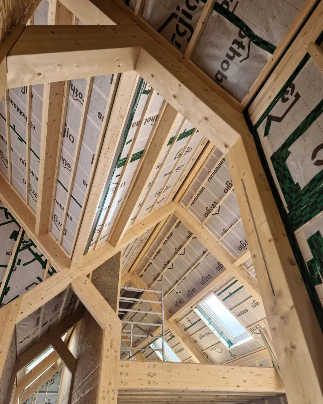 Post and beam timber structure interior with exposed beams and roof framing