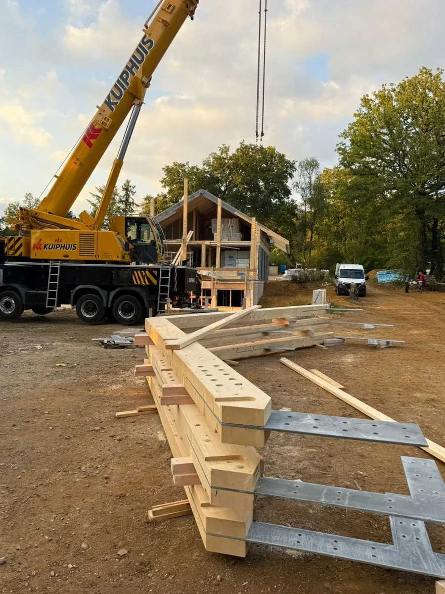 Timber components and crane prepared for site assembly