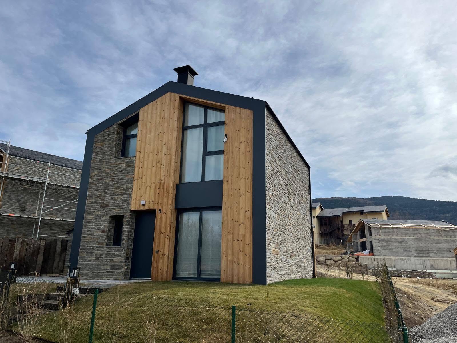 Tall glazed front elevation of the hybrid residence