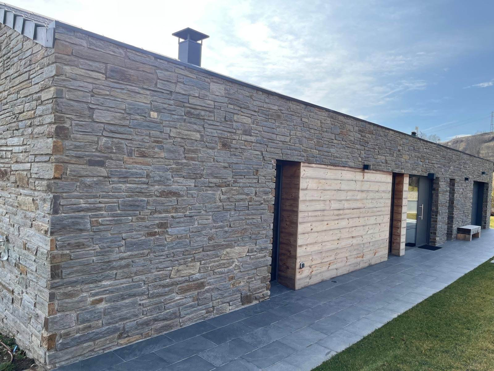 Stone residence with timber garage door