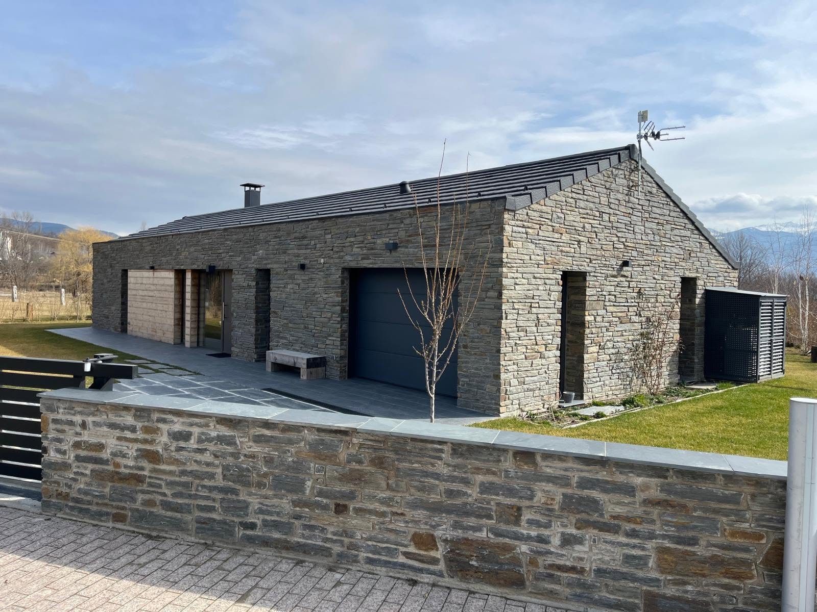 Entrance elevation and boundary wall of the stone residence