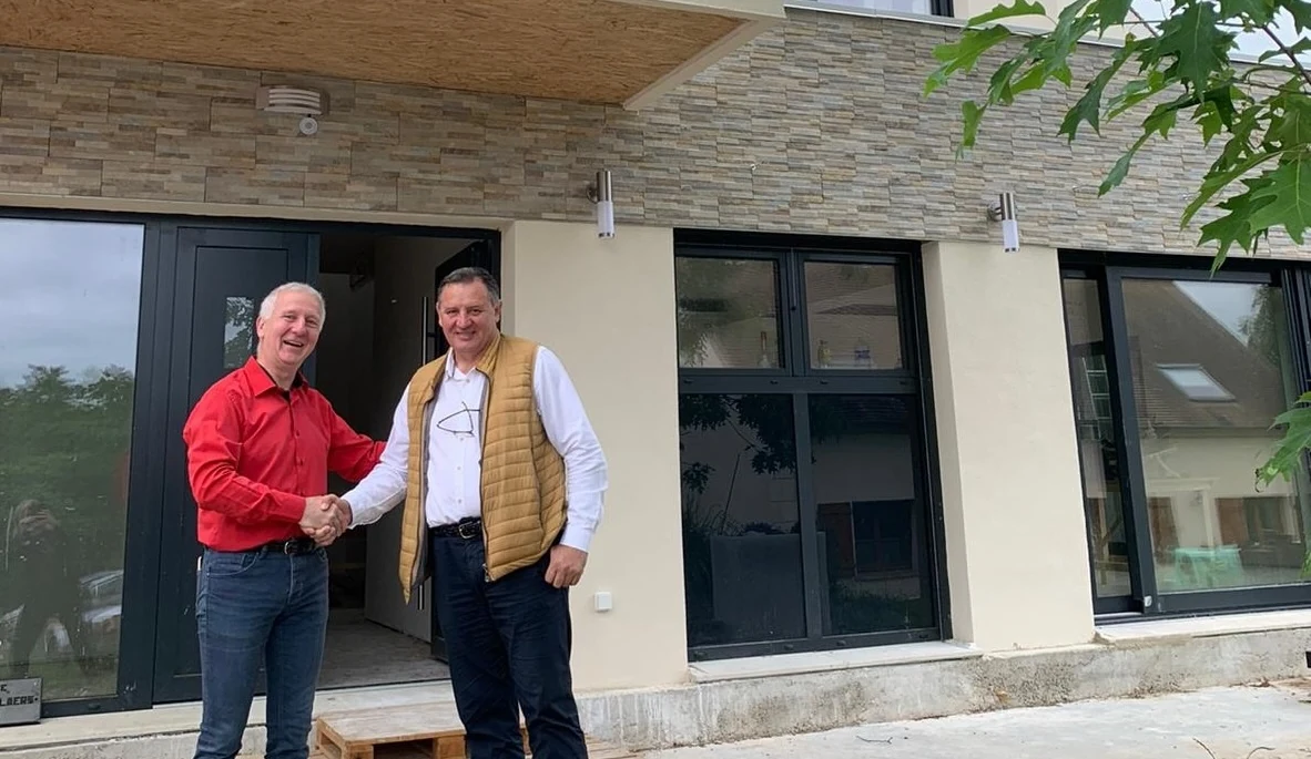 Debargue France clients in front of completed house