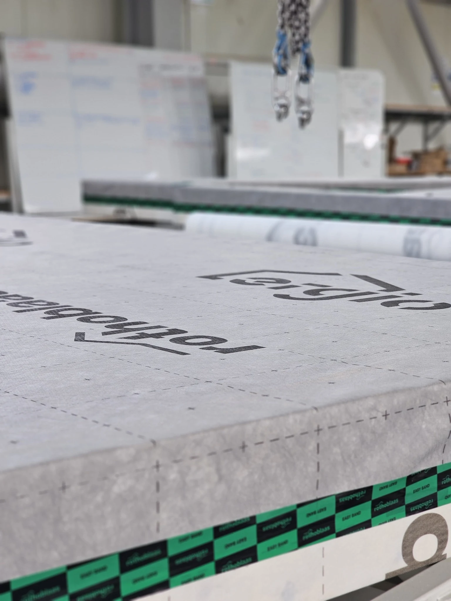 Close-up of a prefabricated timber frame panel in production with Rothoblaas membrane applied