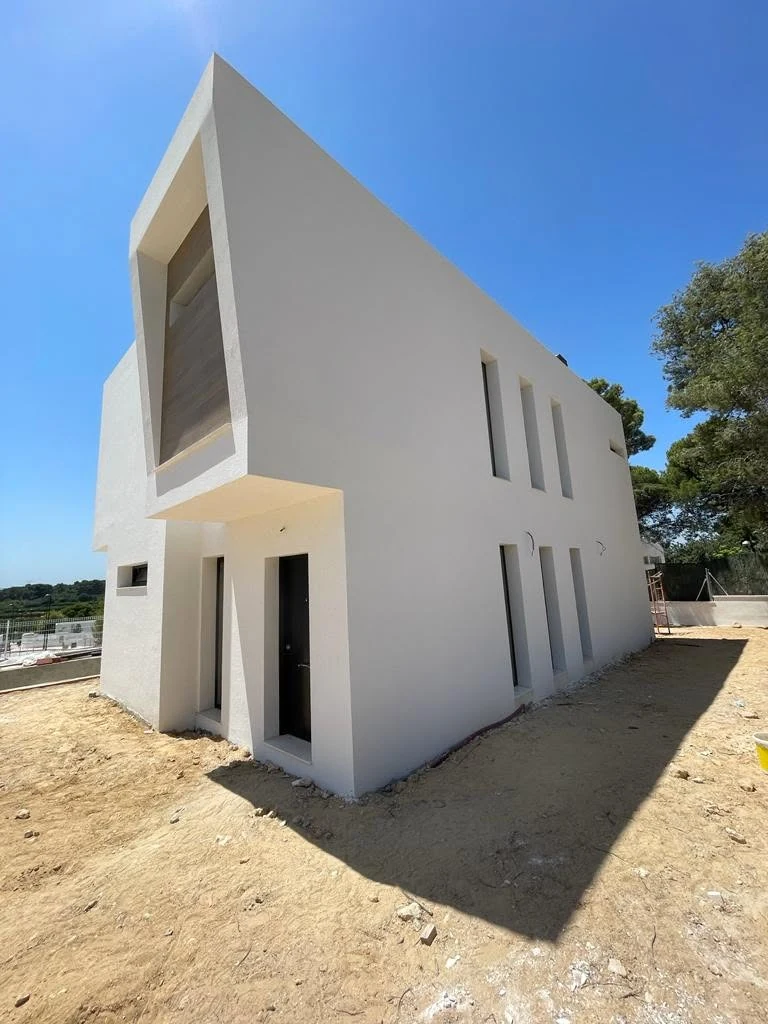 Entrance-side view of the Torrent residence during final exterior completion