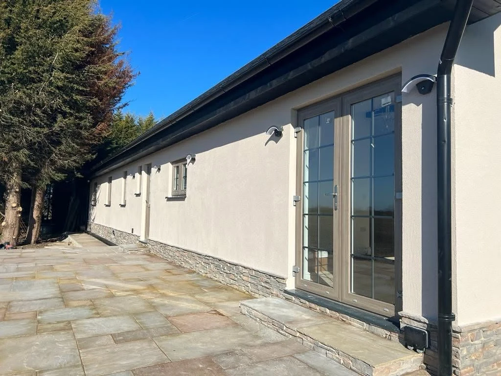 Long paved patio elevation with glazed doors