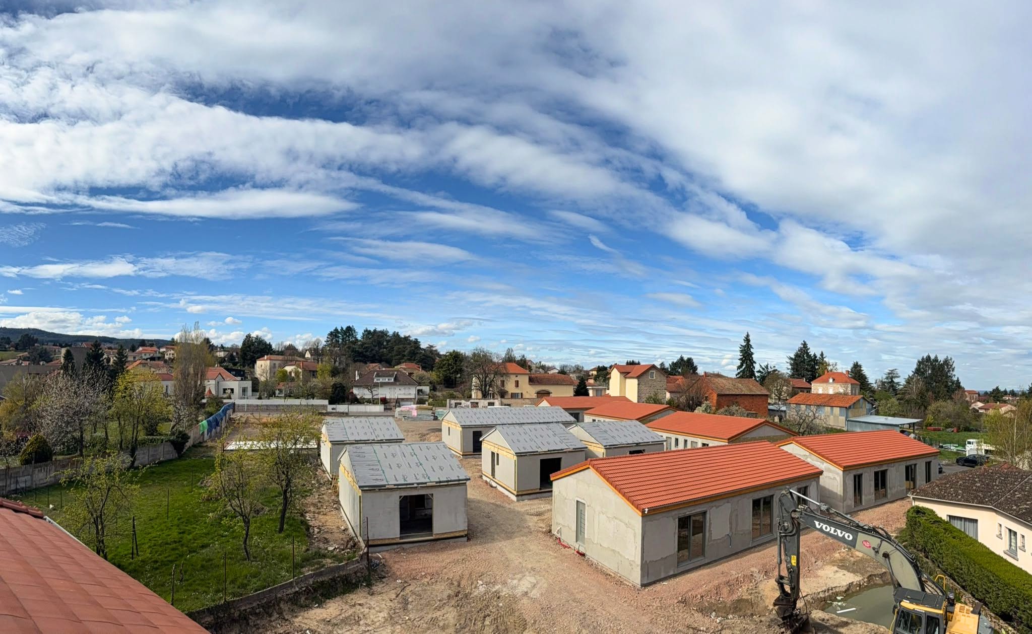 Aerial progress view of Village Seniors 2 under a cloudy sky